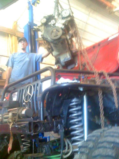 1992 Ford Bronco - Engine removal in progress with a hoist and chains.