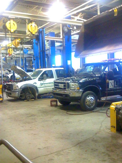 1992 Ford Bronco - Photograph of trucks in a service garage, not a technical document.