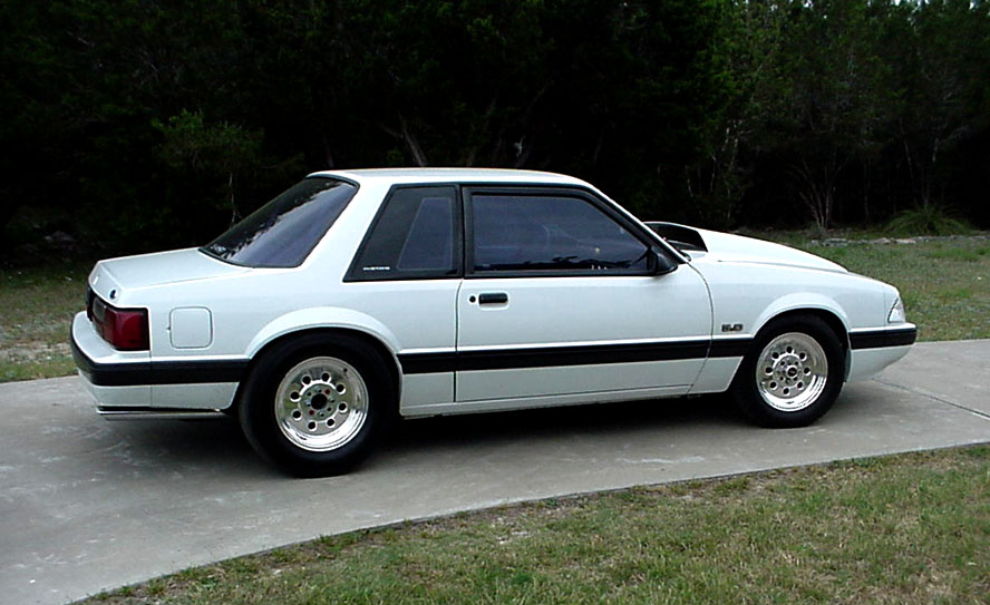 white fox body coupe, side view, aftermarket wheels, hood scoop, 5.0 badge