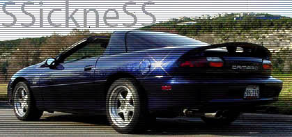 1999 Ford Mustang - A blue coupe with a spoiler and chrome wheels is parked outdoors.