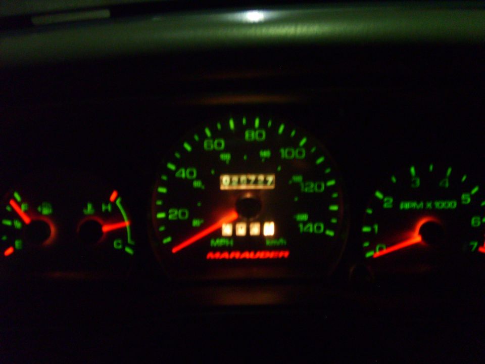 Illuminated Marauder gauge cluster at night with 140 mph speedometer and tachometer