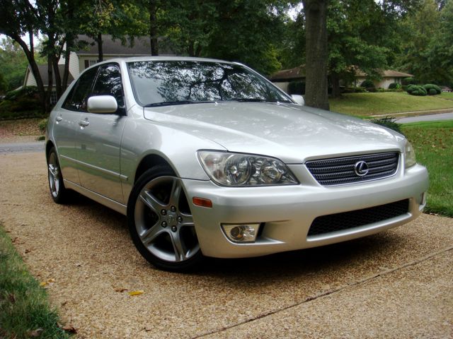 Silver Lexus IS 300 sedan parked on a suburban driveway, front three-quarter view