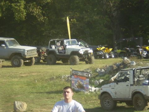 1997 Jeep Wrangler - A white Jeep Wrangler is parked on a grassy field next to a sign that reads "PERFORMANCE". Several other off-road vehicles and ATVs are vis…