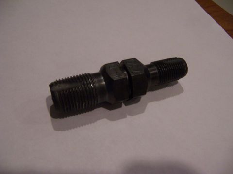 1987 Ford Bronco - A close-up view of a metal component with threaded ends and a hexagonal section.