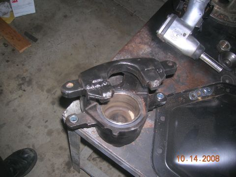 1985 Ford Bronco - A brake caliper and differential cover are shown on a workbench, with an impact wrench nearby. The photo is dated 10.14.2008.