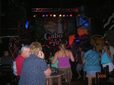 1985 Ford Bronco - A band performs on stage at a venue with a "Cabo" logo, while people dance in the foreground.
