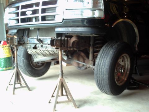 1996 Ford Bronco - Front end of a 1996 Ford Bronco lifted on jack stands for maintenance or repair.