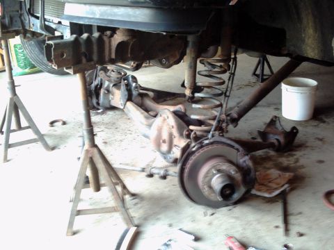 1996 Ford Bronco - Vehicle undergoing repair, showing the rear axle and suspension system.