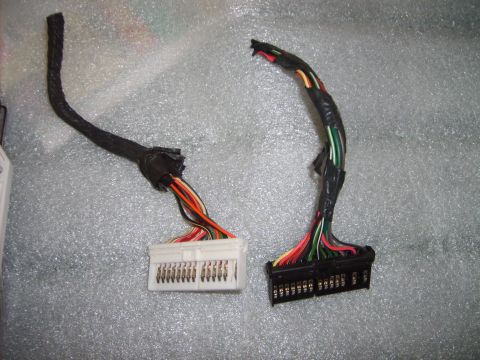 1993 Ford Crown Victoria - Two automotive wiring harness connectors are shown, each with a bundle of colored wires.