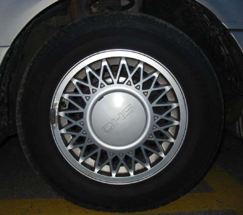 1990 Ford Taurus - The 'SHO' badging on the wheel hub clearly identifies this as a Ford Taurus SHO model.