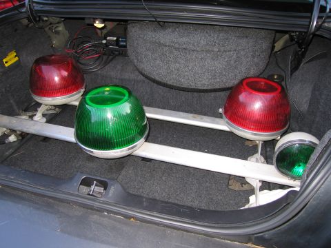 2001 Ford Crown Victoria - Emergency lights are stored in the trunk of a vehicle, alongside a spare tire and wiring.
