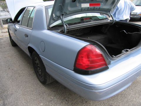 2001 Ford Crown Victoria - This 2001 Ford Crown Victoria is shown from the rear quarter with its trunk and hood open.