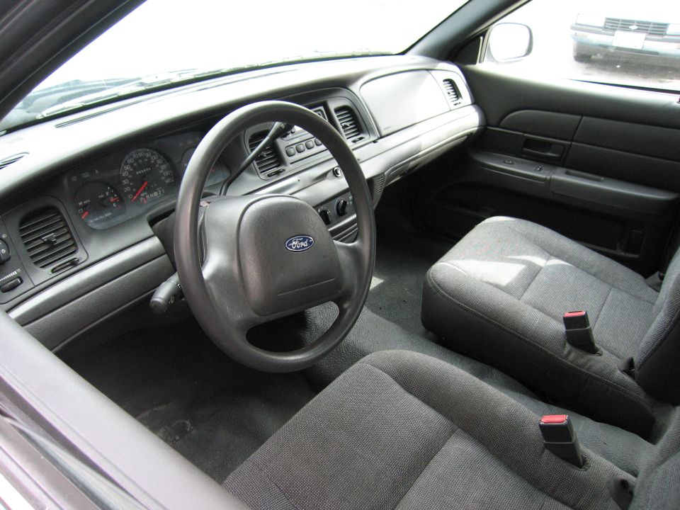 2001 Ford Crown Victoria interior showing dashboard, steering wheel with Ford logo, and front seats