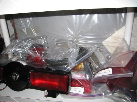 2001 Ford Crown Victoria - Various car tail light assemblies and parts are stored in clear plastic bags.