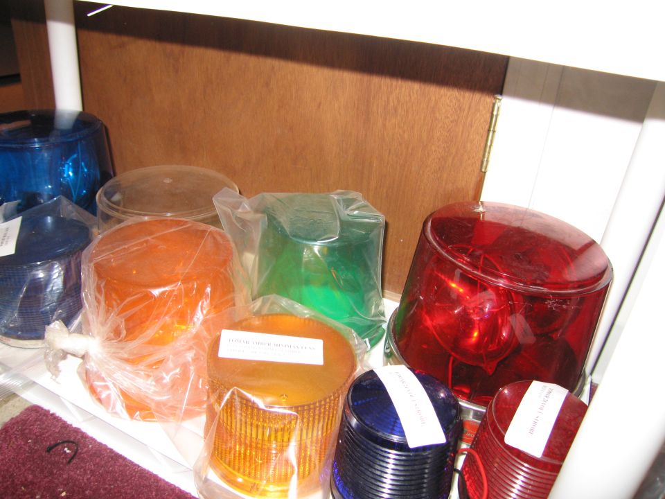 Assortment of red, blue, orange, and green emergency light lenses