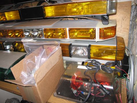 2001 Ford Crown Victoria - Various light bars and a box of parts are stored together.