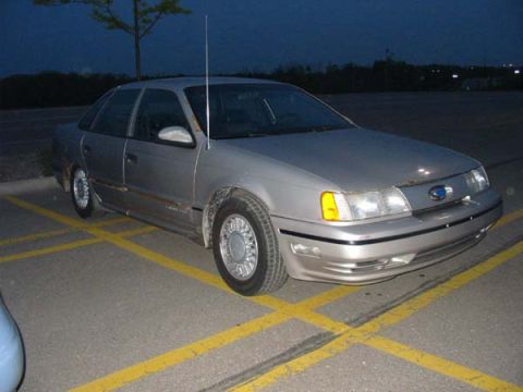 1990 Ford Taurus - This 1990 Ford Taurus is seen parked in a lot at dusk.