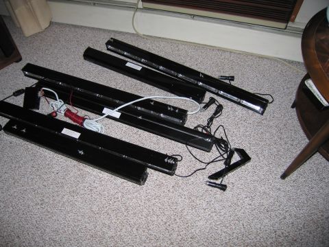2001 Ford Crown Victoria - Four black LED light bars are laid out on a carpeted floor with their associated wiring and connectors.