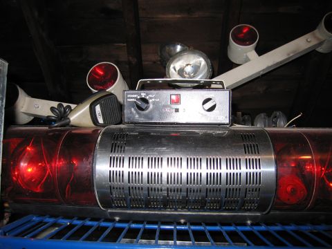 2001 Ford Crown Victoria - Close-up of an emergency vehicle's light bar and control unit, red lights and a microphone.