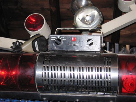 2001 Ford Crown Victoria - Close-up of emergency vehicle equipment including a light bar, microphone, and control unit.