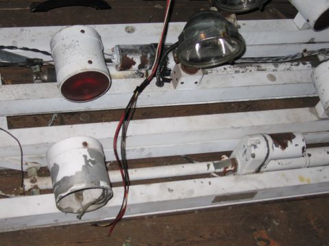 2001 Ford Crown Victoria - A close-up view of a white light fixture with multiple lamps and exposed wiring.