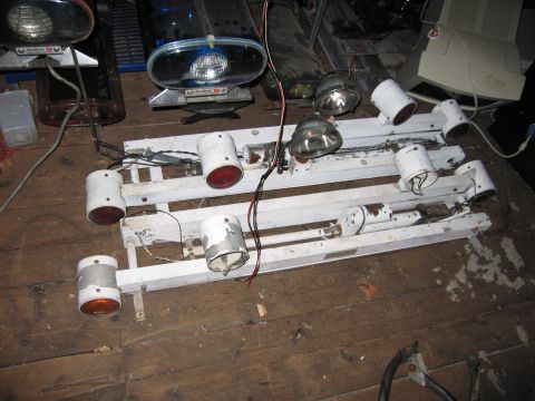 2001 Ford Crown Victoria - An emergency light bar with multiple lights and exposed wiring lies on a wooden floor.