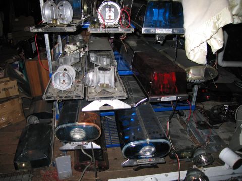 2001 Ford Crown Victoria - Collection of various emergency vehicle light bars and parts, some appear to be in working condition.