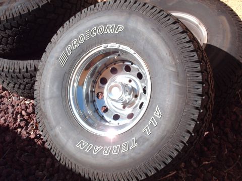 1978 Ford Bronco - Close-up of Pro Comp All Terrain tires mounted on shiny chrome wheels.