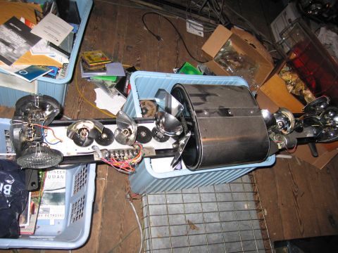 2001 Ford Crown Victoria - Disassembled car part assembly with chrome accents and wiring, resting in blue plastic bins.