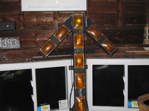 2001 Ford Crown Victoria - Arrow-shaped light bar with multiple amber lenses, possibly for a vehicle or sign.