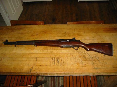 1996 Ford Bronco - An M1 Garand rifle is displayed on a wooden surface, with a portion of a door visible in the background.