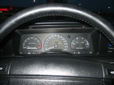 1990 Ford Taurus - Dashboard view of a 1990 Ford Taurus, including speedometer and tachometer.