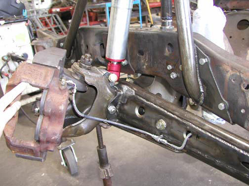 Front suspension and brake assembly with red-accented shock absorber