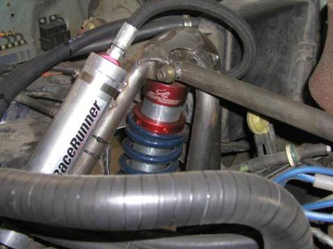 1984 Ford Bronco - Close-up of suspension components in a vehicle's engine bay, a RaceRunner shock.
