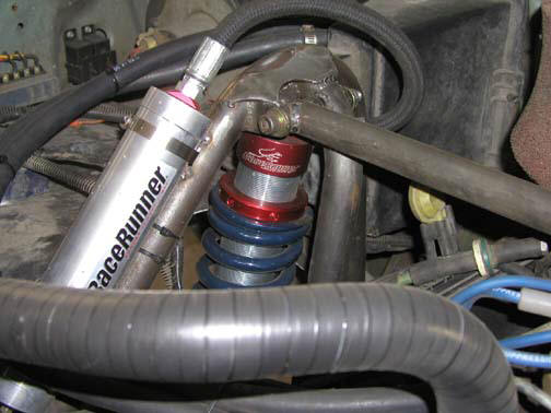 Engine bay detail showing a RaceRunner shock absorber and suspension components