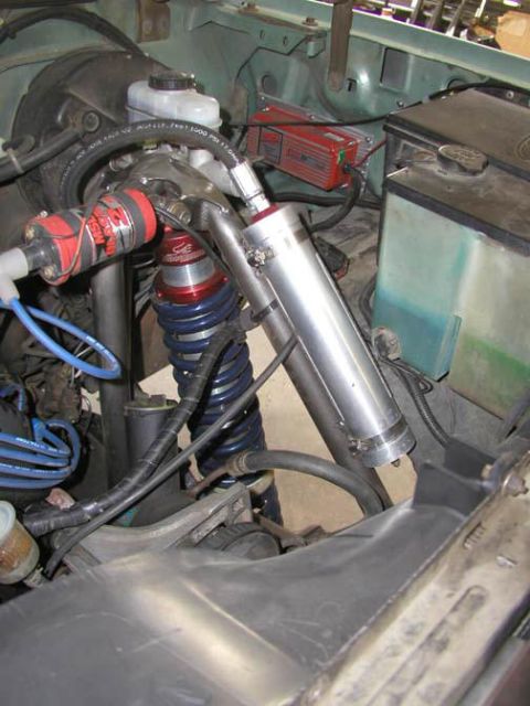 1984 Ford Bronco - Custom engine bay components are visible, including a large shock absorber and a red ignition box.