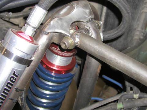 1984 Ford Bronco - Close-up of off-road suspension components, including a shock absorber and coil spring.