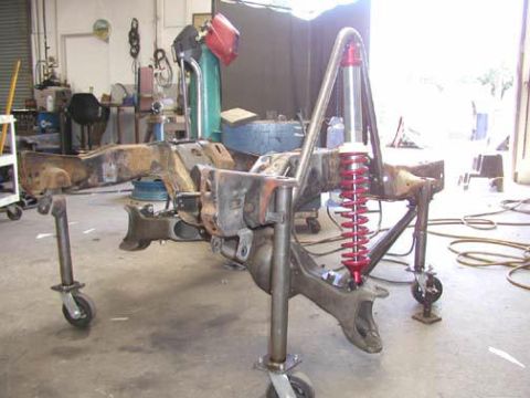 1984 Ford Bronco - Workshop scene showing a vehicle frame with a custom suspension setup.