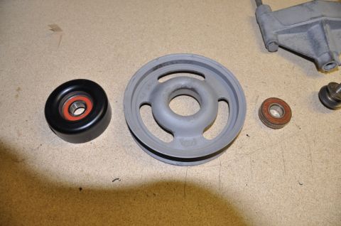 1996 Ford Bronco - Several engine pulleys and bearings are shown, including a black tensioner pulley and a gray idler pulley.
