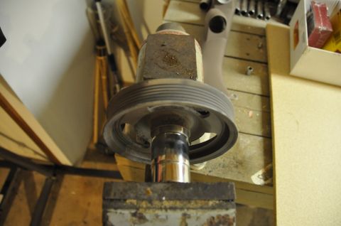 1996 Ford Bronco - A pulley is secured in a vise, ready for servicing.