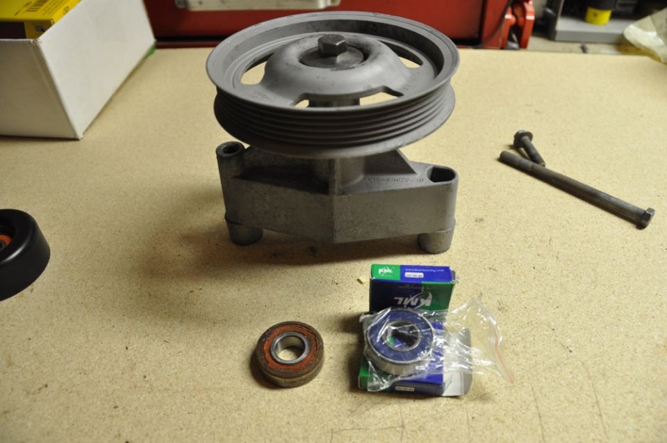 Pulley assembly with two bearings and a bolt on a workbench