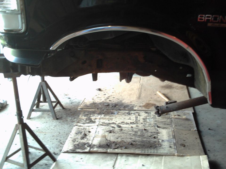 1996 Ford Bronco side view of frame and undercarriage on jack stands