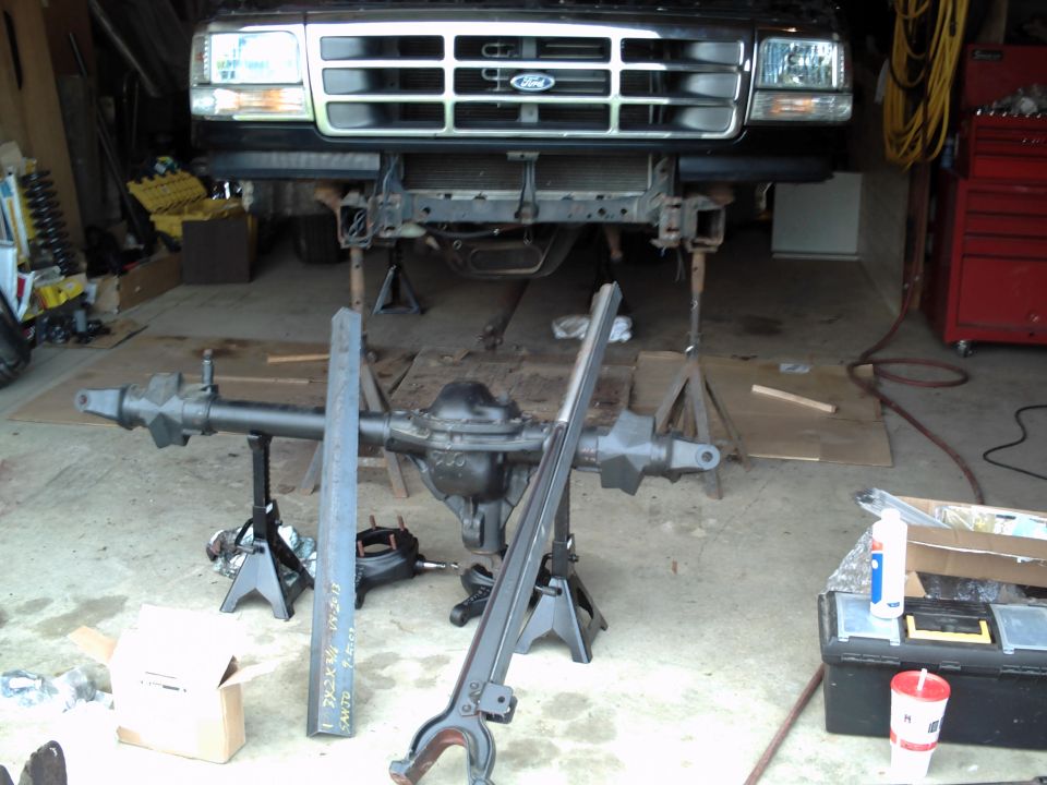 1996 Ford Bronco front end on jack stands, with front axle removed and resting on jack stands