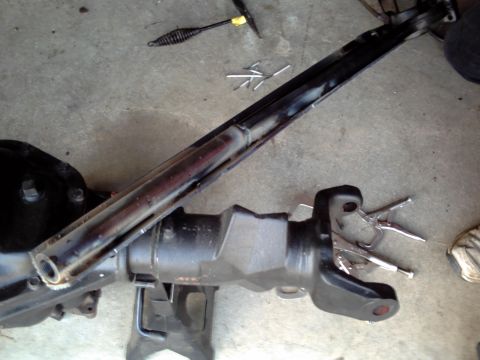 1996 Ford Bronco - A vehicle's axle assembly is shown on jack stands, with tools scattered around the work area.