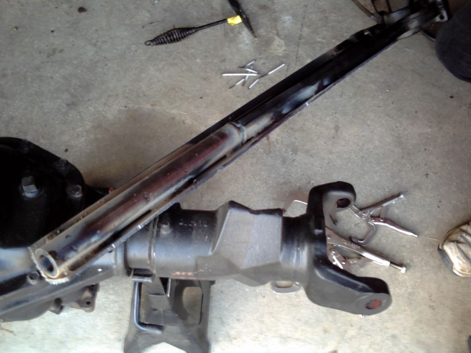 Vehicle axle assembly on jack stands with tools nearby