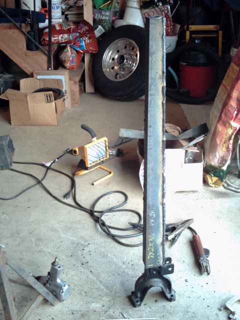 1996 Ford Bronco - A metal bracket with visible text and welding marks, likely a vehicle part.
