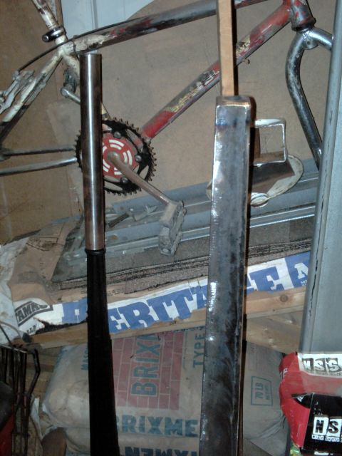 1996 Ford Bronco - A cluttered garage scene shows parts of a bicycle and various metal objects, with some bags and building materials in the background.