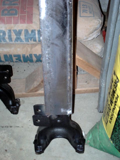 1996 Ford Bronco - A close-up view of a vehicle frame component, likely a suspension or chassis part, showing its mounting points.