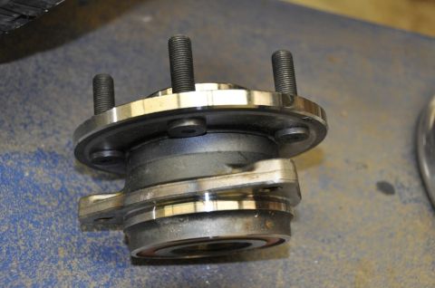 1996 Ford Bronco - A close-up view of a vehicle's wheel hub assembly, showing its mounting studs and bearing.