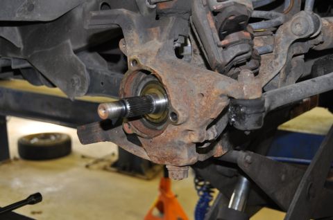 1996 Ford Bronco - Close-up view of a vehicle's front wheel hub assembly, showing the splined axle shaft and bearing.